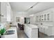 Open kitchen featuring white cabinets, stone countertops, stainless steel sink and modern lighting at 910 Kushiwah Creek Ct, Charleston, SC 29412