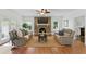 Inviting living room with a brick fireplace, ceiling fan and comfortable seating arrangement at 910 Kushiwah Creek Ct, Charleston, SC 29412