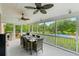 Spacious screened porch with dining area, ceiling fans, and a view of the pool at 910 Kushiwah Creek Ct, Charleston, SC 29412