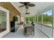 Relaxing screened porch with dining table, chairs, a mini fridge, and fan at 910 Kushiwah Creek Ct, Charleston, SC 29412