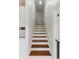 Clean stairway with wooden treads, white risers, and a minimalist design aesthetic at 910 Kushiwah Creek Ct, Charleston, SC 29412