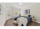 Well-lit bedroom with a door leading to a balcony area and a view of trees at 1012 Basildon Rd, Mount Pleasant, SC 29466
