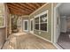 This is a screened patio with wood floors, a white door, and views of the surrounding neighborhood at 1012 Basildon Rd, Mount Pleasant, SC 29466