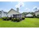 Spacious backyard with a screened-in porch, lush lawn and manicured landscaping at 103 Savannah River Dr, Summerville, SC 29485