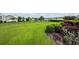 Manicured lawn with garden bed and a decorative black metal fence for added charm at 103 Savannah River Dr, Summerville, SC 29485