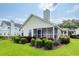 Well-maintained backyard featuring a screened porch and lush landscaping at 103 Savannah River Dr, Summerville, SC 29485