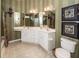 Elegant bathroom with double sinks, vanity, decorative mirrors, and a toilet at 103 Savannah River Dr, Summerville, SC 29485