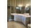 Well-lit bathroom with a wide vanity and double sinks, offering generous counter space, and cabinet storage at 103 Savannah River Dr, Summerville, SC 29485