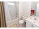 Well-lit bathroom features a shower-tub combo, vanity, and neutral wallpaper at 103 Savannah River Dr, Summerville, SC 29485