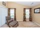 Bedroom with seating, window with floral curtains, and neutral walls at 103 Savannah River Dr, Summerville, SC 29485