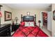 Comfortable bedroom with black furnishings and patterned red and black bedding at 103 Savannah River Dr, Summerville, SC 29485