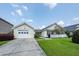 Lovely home featuring an attached garage, charming white fence and manicured lawn at 103 Savannah River Dr, Summerville, SC 29485