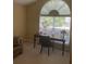 Bright office space featuring a dark wood desk and large arched window, perfect for working from home at 103 Savannah River Dr, Summerville, SC 29485