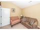 Bright sitting area featuring a red loveseat, brown sofa, and neutral walls at 103 Savannah River Dr, Summerville, SC 29485