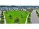 An aerial view of a well-maintained neighborhood park surrounded by colorful homes and lush greenery at 109 Medford St, Summerville, SC 29486
