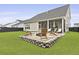 Outdoor patio features backyard views, comfortable seating, and a stone fire pit area at 109 Medford St, Summerville, SC 29486