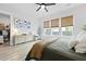 Bright bedroom with wood floors, ceiling fan, natural light from large windows, and neutral decor at 109 Medford St, Summerville, SC 29486