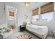Bright bedroom featuring a decorative light fixture, bamboo shades, and a comfortable bed at 109 Medford St, Summerville, SC 29486