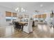 Open dining area with a large table, stylish chandelier, and abundant natural light at 109 Medford St, Summerville, SC 29486