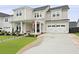 Charming two-story home featuring a welcoming front porch, an attached two-car garage, and manicured landscaping at 109 Medford St, Summerville, SC 29486