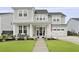 Inviting two-story home featuring a landscaped yard, covered porch, and attached two-car garage at 109 Medford St, Summerville, SC 29486