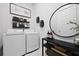 Stylish laundry room features a large mirror, dark floating shelves, and modern washer/dryer at 109 Medford St, Summerville, SC 29486