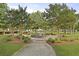 A manicured park fountain is surrounded by walking paths, benches, and shade trees at 109 Medford St, Summerville, SC 29486