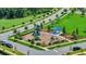 An aerial view of a well-maintained neighborhood playground with slides, climbing structures, and a shaded picnic area at 109 Medford St, Summerville, SC 29486
