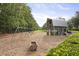 Community playground and playhouse nestled on a wooded lot with swings and climbing at 109 Medford St, Summerville, SC 29486