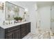 Bathroom vanity with double sinks, marble floors and countertop, and decorative fixtures at 1106 Meadowcroft Ln, Mount Pleasant, SC 29464