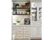 Bright kitchen featuring custom cabinets, marble countertops, and decorative shelving at 1106 Meadowcroft Ln, Mount Pleasant, SC 29464
