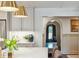 Kitchen featuring marble counters, stainless appliances, and an arched doorway leading into another room at 1106 Meadowcroft Ln, Mount Pleasant, SC 29464