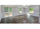 Bright dining area with luxury vinyl plank flooring and sliding glass doors leading to a deck, perfect for entertaining at 117 Dairy Ln, Cottageville, SC 29435