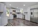 Modern kitchen featuring stainless steel appliances, sleek countertops, and ample cabinet space, perfect for cooking at 117 Dairy Ln, Cottageville, SC 29435