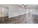 Bright, open living room with hardwood floors, crown molding, and entry to a modern kitchen and tile bathroom at 117 Dairy Ln, Cottageville, SC 29435