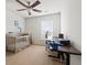 A room with a crib, desk, ceiling fan, and window, offering a flexible space at 1170 Deerberry Rd, Hanahan, SC 29410
