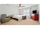 Bright bedroom with a ceiling fan, white walls, and a comfortable chair at 1170 Deerberry Rd, Hanahan, SC 29410