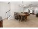 Spacious dining room with neutral tones and ample space for seating, featuring a classic chandelier and a stairway to the left at 1170 Deerberry Rd, Hanahan, SC 29410