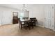 Cozy dining room with neutral tones and ample space for seating, featuring a classic chandelier and convenient access to nearby rooms at 1170 Deerberry Rd, Hanahan, SC 29410