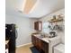 A kitchen featuring wood cabinets, a stainless steel sink, hanging pot rack, and black refrigerator at 1170 Deerberry Rd, Hanahan, SC 29410