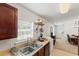 A kitchen offering a stainless steel sink, wood cabinets, and a view into the dining and living areas at 1170 Deerberry Rd, Hanahan, SC 29410