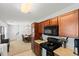 Cozy kitchen features brown cabinetry, an electric stove, and a microwave above the stove, as well as a dining area at 1170 Deerberry Rd, Hanahan, SC 29410