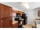 Functional kitchen with dark cabinets, black appliances, and ample counter space for meal preparation and everyday cooking needs at 1170 Deerberry Rd, Hanahan, SC 29410