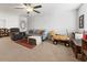 Bright living room with neutral tones, plush seating, and a cozy atmosphere, illuminated by a modern ceiling fan at 1170 Deerberry Rd, Hanahan, SC 29410