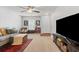 Bright and airy living room featuring neutral tones, plush seating, and a large TV, perfect for relaxation and entertainment at 1170 Deerberry Rd, Hanahan, SC 29410