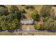 Overhead view of a home with cars parked on the street near trees and a large yard at 1211 Lem Rd, Cordesville, SC 29434