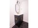 Modern bathroom features a black vanity with gold hardware and a stylish oval mirror at 1211 Lem Rd, Cordesville, SC 29434