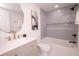 Bright bathroom features a grey tiled shower/tub combo, unique mirror, and marble vanity at 1211 Lem Rd, Cordesville, SC 29434