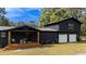 Beautiful home with sleek black exterior, wooden porch, and a two-car garage at 1211 Lem Rd, Cordesville, SC 29434