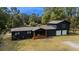 Stunning home exterior features a modern black facade and well-manicured lawn at 1211 Lem Rd, Cordesville, SC 29434